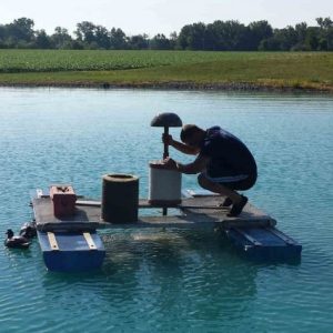 An Aquatek Water Conditioning Technician changing a pond filter.