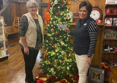 Photo of Sauder Village Employees holding a gift certificate